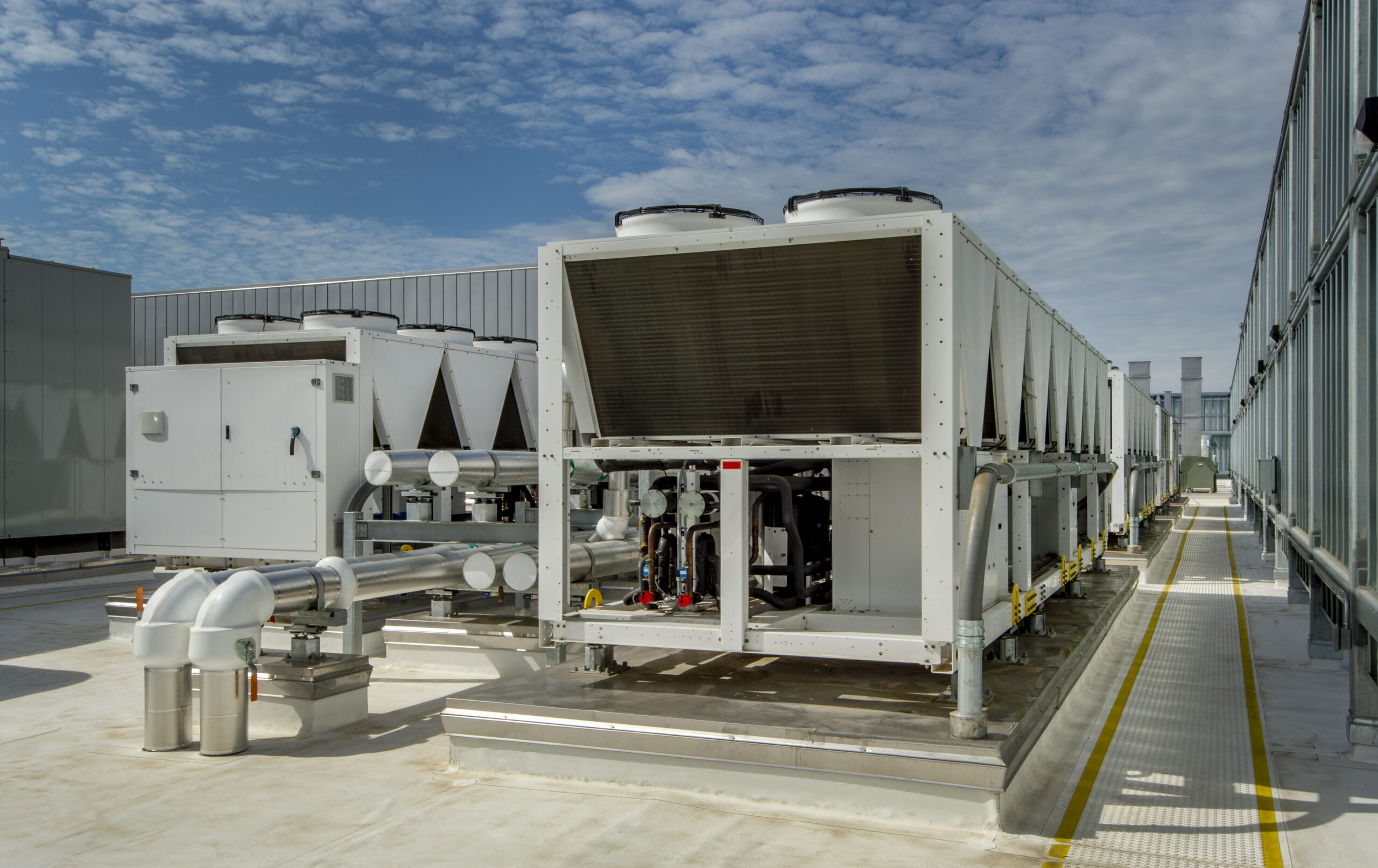 Air-cooled chillers on a commercial rooftop after plant upgrade